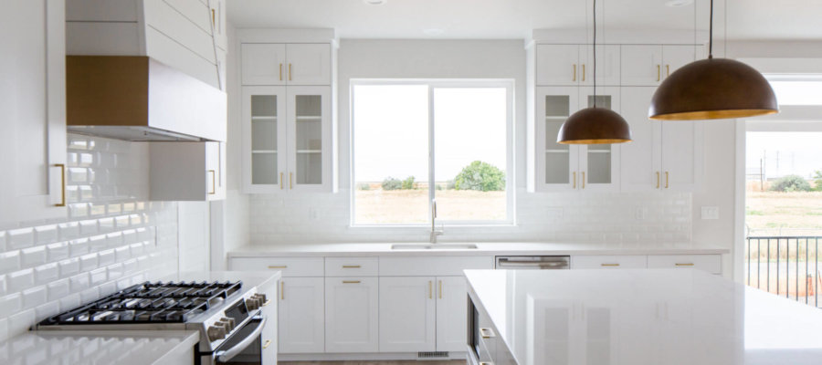 New home kitchen with white cabinets & white tile backsplash.